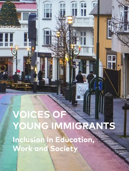 A rainbow-colored pedestrian street in a European city with text overlay: "VOICES OF YOUNG IMMIGRANTS: Inclusion in Education, Work and Society." The background shows people walking, traditional buildings, and festive holiday decorations.